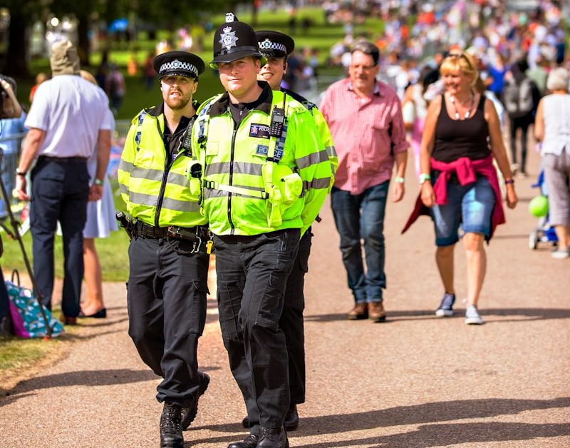 three policemen patrolling on the street